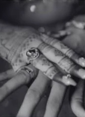 Black and white detail of hands with rings